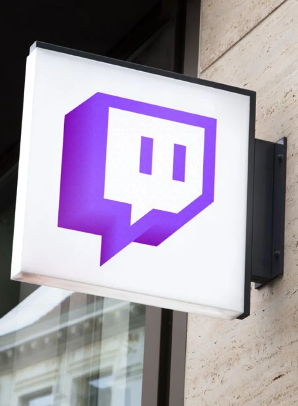 An extruded Glitch on a lit street sign mounted to a building